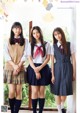 A group of young women in school uniforms posing for a magazine.